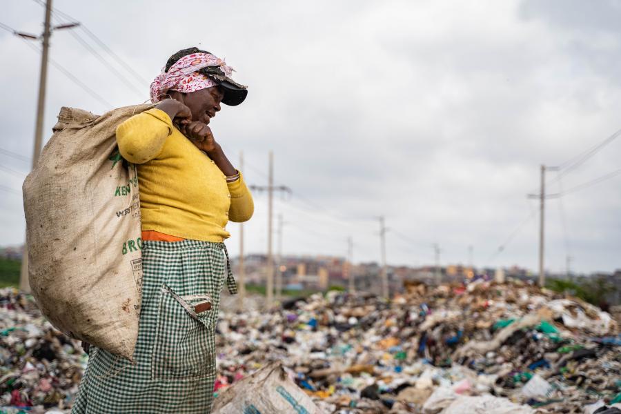 Woman collecting trash on the Dandora dumpsite.